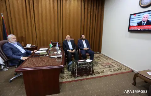 Hamas Chief Ismail Haniyeh watches a TV broadcast of a deal signing between Hamas and Fatah in Cairo, at his office in Gaza City October 12, 2017. Rival Palestinian factions Hamas and Fatah have reached agreement on aspe...