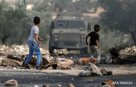 Palestinian protesters hurl stones towards Israeli security forces during clashes following a demonstration against the expropriation of Palestinian land by Israel in the village of Kfar Qaddum, near Nablus in the occupi...