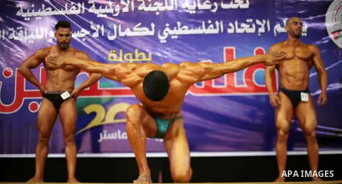 Palestinian participants pose during a bodybuilding competition, which organized by Palestinian Federation of Bodybuilding and Fitness (PFBB), in Gaza city on October 20, 2017. Photo by Mohammed Asad