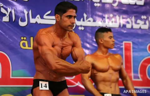 A Palestinian participant poses during a bodybuilding competition, which organized by Palestinian Federation of Bodybuilding and Fitness (PFBB), in Gaza city on October 20, 2017. Photo by Mohammed Asad