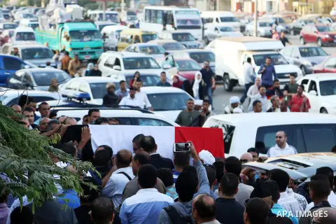 Egyptians carry the coffin of Police captain Ahmed Fayez during his funeral outside El Hosary Mosque in the capital Cairo's western suburb of Sixth of October, on October 21, 2017. Fayez died the previous night during an...
