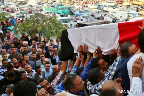 Egyptians carry the coffin of Police captain Ahmed Fayez during his funeral outside El Hosary Mosque in the capital Cairo's western suburb of Sixth of October, on October 21, 2017. Fayez died the previous night during an...