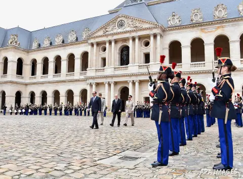 French Foreign Affairs Minister Jean-Yves Le Drian and Egypt's President Abdel Fattah al-Sisi listen to the national anthem with Paris' military Governor Bruno le Ray as they stand in front of an honour guard at the Hote...