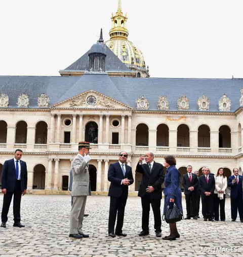 Egyptian President Abdel Fattah al-Sisi, French Foreign Affairs Minister Jean-Yves Le Drian and Paris military Governor Bruno Le Ray stand in front of the statue of Napoleon during a military ceremony at the Hotel des In...