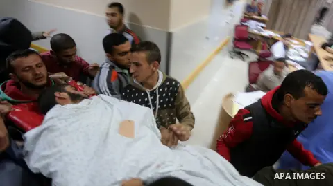 The body of Palestinian Marwan Alagha,22, is carried by mourners after he was killed when Israel blew up what it said was a tunnel stretching from the Gaza Strip into its territory, at Naser hospital in Khan Yunis, in th...