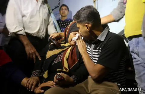 A Palestinian woman reacts after her relative was killed after Israel blew up what it said was a tunnel stretching from the Gaza Strip into its territory, at a morgue at al-Aqsa hospital in Deir el-Balah, in central Gaza...