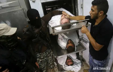 The bodies of Palestinians killed after Israel blew up what it said was a tunnel stretching from the Gaza Strip into its territory, lie at a morgue at al-Aqsa hospital in Deir el-Balah, in central Gaza, on October 30, 20...