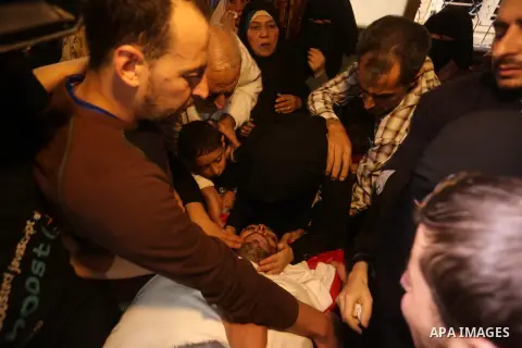 Palestinian relatives of Hassan Abu Hassanin who were killed the previous day in an Israeli operation to blow up a tunnel stretching from the Gaza Strip into Israel, mourn during his funeral in Bureij refugee camp in cen...