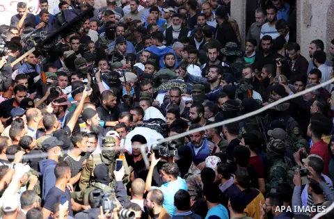 Palestinian mourners carry the body of one of the Palestinians killed in an Israeli operation to blow up a tunnel stretching from the Gaza Strip into Israel during their funeral in Bureij refugee camp in central Gaza Str...