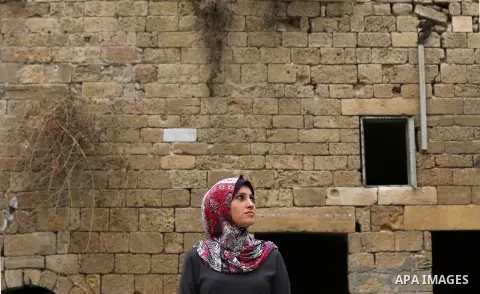 A Palestinian woman visits al-Kamiliya school in the east of Gaza city, which was built by the Mamluks on November 5, 2017. Mamluk was the knightly military caste in Egypt in the Middle Ages, which developed from the ran...