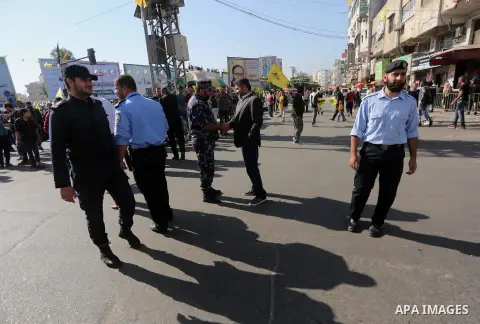 Palestinian policemen stand guard before a festival to commemorate the 13th anniversary of the death of late Palestinian leader Yasser Arafat in Gaza city on November 11, 2017. Photo by Mohammed Asad