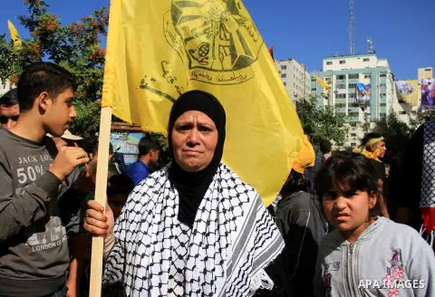 Palestinian Fatah supporters take part in a rally to mark the 13th anniversary of the death of late Palestinian leader Yasser Arafat in Gaza City on November 11, 2017. Photo by Mahmoud Ajour