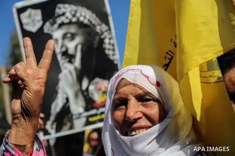 Palestinian Fatah supporters take part in a rally to mark the 13th anniversary of the death of late Palestinian leader Yasser Arafat in Gaza City on November 11, 2017. Photo by Mohammed Dahman