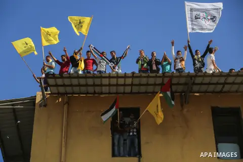 Palestinian Fatah supporters take part in a rally to mark the 13th anniversary of the death of late Palestinian leader Yasser Arafat in Gaza City on November 11, 2017. Photo by Mohammed Dahman