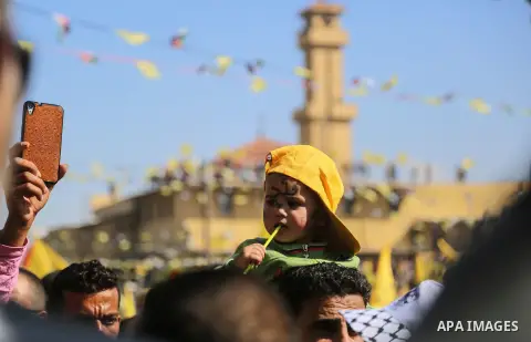 Palestinian Fatah supporters take part in a rally to mark the 13th anniversary of the death of late Palestinian leader Yasser Arafat in Gaza City on November 11, 2017. Photo by Mohammed Dahman