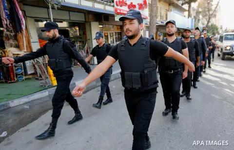 Palestinian security forces take part a parade marking the 29th anniversary of Palestinian Declaration of Independence, in the West Bank city of Hebron on November 14, 2017. Photo by Wisam Hashlamoun