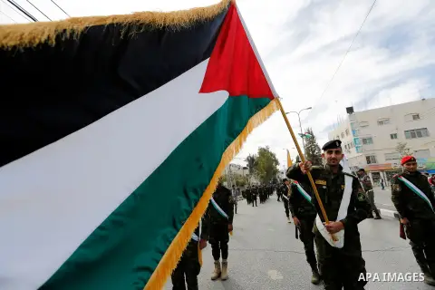 Palestinian security forces take part a parade marking the 29th anniversary of Palestinian Declaration of Independence, in the West Bank city of Hebron on November 14, 2017. Photo by Wisam Hashlamoun