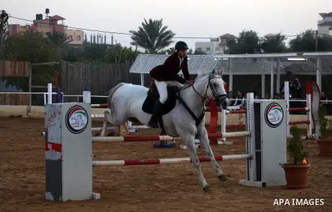 A Palestinian competitor rides a horse during the equestrian championship in Gaza City, Gaza on November 17, 2017. Photo by Mohammed Asad