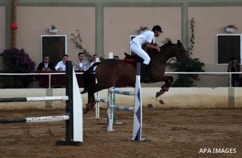 A Palestinian competitor rides a horse during the equestrian championship in Gaza City, Gaza on November 17, 2017. Photo by Mohammed Asad