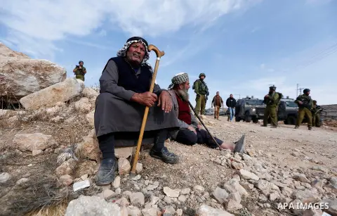 Israeli security forces stand guard as an Israeli army bulldozer closes a road in the West Bank city of Hebron after Palestinian municipality of Hebron reopened the road after 17 years of closure by the Israeli army in t...