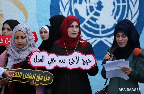 Palestinian graduates hold placards during a protest to demand their rights, in front of the headquarters United Nations Relief and Works Agency (UNRWA) in Gaza city on November 20, 2017. Photo by Mohammed Asad