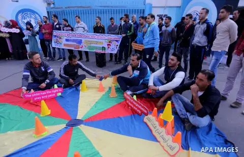 Palestinian graduates hold placards during a protest to demand their rights, in front of the headquarters United Nations Relief and Works Agency (UNRWA) in Gaza city on November 20, 2017. Photo by Mohammed Asad