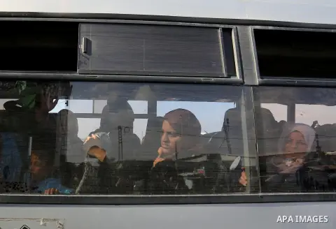 Palestinians look through a bus window waiting at the Rafah border crossing with Egypt before being allowed to pass out of the southern Gaza Strip on November 20, 2017, following its opening for three days for the first...