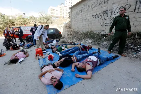 Members of Palestinian security forces and Civil Defense take part in a security drill in the West Bank city of Hebron on November 20, 2017. Photo by Wisam Hashlamoun