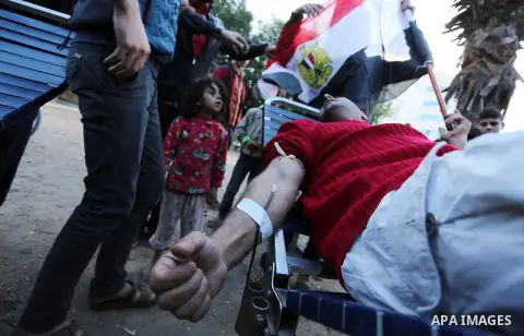 A Palestinian man donates blood for the Egyptian victims in a mourning tent set up for people to pay their respects to the Egyptian victims after the deadly attack on a mosque in Egypt's Sinai, on November 26, 2017 in Ga...