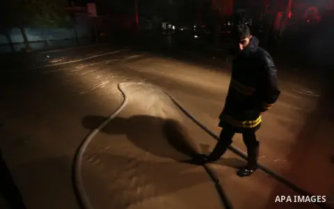 Members of Palestinian Civil Defence work in a flooded street with sewage during a winter storm in Gaza City, on November 27, 2017. Photo by Mohammed Asad