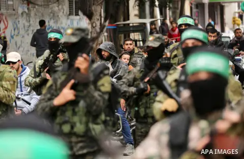 Members of the Ezzedine al-Qassam Brigades, the military wing of the Palestinian Islamist movement Hamas take part during a military parade ahead of the 30th anniversary of Hamas' founding, in Khan Younis in the southern...