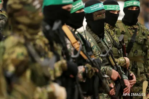 Members of the Ezzedine al-Qassam Brigades, the military wing of the Palestinian Islamist movement Hamas take part during a military parade ahead of the 30th anniversary of Hamas' founding, in Khan Younis in the southern...