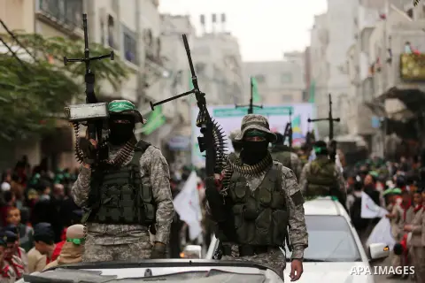 Members of the Ezzedine al-Qassam Brigades, the military wing of the Palestinian Islamist movement Hamas take part during a military parade ahead of the 30th anniversary of Hamas' founding, in Khan Younis in the southern...