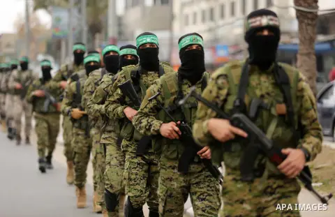Members of the Ezzedine al-Qassam Brigades, the military wing of the Palestinian Islamist movement Hamas take part during a military parade ahead of the 30th anniversary of Hamas' founding, in Khan Younis in the southern...