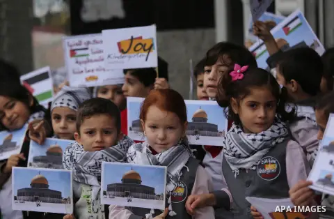 Palestinian children hold Palestine flags and pictures of Jerusalem during a protest in Gaza city, on December 6, 2017. U.S. officials say President Donald Trump will recognize Jerusalem as Israel's capital Wednesday, De...