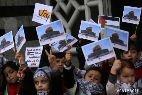 Palestinian children hold Palestine flags and pictures of Jerusalem during a protest in Gaza city, on December 6, 2017. U.S. officials say President Donald Trump will recognize Jerusalem as Israel's capital Wednesday, De...