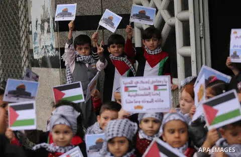 Palestinian children hold Palestine flags and pictures of Jerusalem during a protest in Gaza city, on December 6, 2017. U.S. officials say President Donald Trump will recognize Jerusalem as Israel's capital Wednesday, De...