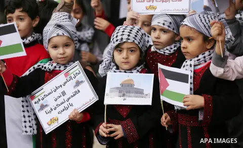 Palestinian children hold Palestine flags and pictures of Jerusalem during a protest in Gaza city, on December 6, 2017. U.S. officials say President Donald Trump will recognize Jerusalem as Israel's capital Wednesday, De...
