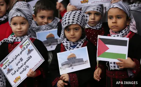 Palestinian children hold Palestine flags and pictures of Jerusalem during a protest in Gaza city, on December 6, 2017. U.S. officials say President Donald Trump will recognize Jerusalem as Israel's capital Wednesday, De...