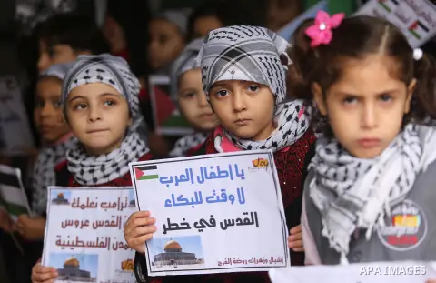 Palestinian children hold Palestine flags and pictures of Jerusalem during a protest in Gaza city, on December 6, 2017. U.S. officials say President Donald Trump will recognize Jerusalem as Israel's capital Wednesday, De...