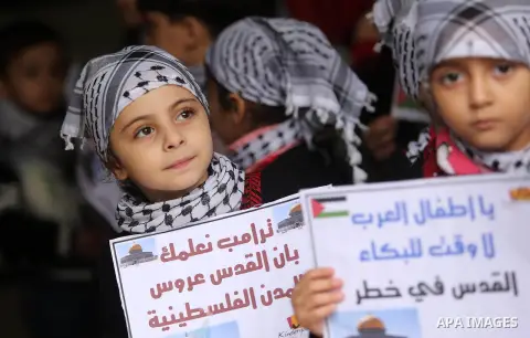 Palestinian children hold Palestine flags and pictures of Jerusalem during a protest in Gaza city, on December 6, 2017. U.S. officials say President Donald Trump will recognize Jerusalem as Israel's capital Wednesday, De...