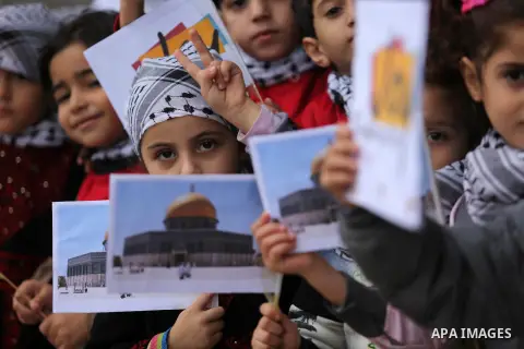 Palestinian children hold Palestine flags and pictures of Jerusalem during a protest in Gaza city, on December 6, 2017. U.S. officials say President Donald Trump will recognize Jerusalem as Israel's capital Wednesday, De...