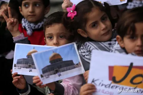 Palestinian children hold Palestine flags and pictures of Jerusalem during a protest in Gaza city, on December 6, 2017. U.S. officials say President Donald Trump will recognize Jerusalem as Israel's capital Wednesday, De...