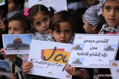 Palestinian children hold Palestine flags and pictures of Jerusalem during a protest in Gaza city, on December 6, 2017. U.S. officials say President Donald Trump will recognize Jerusalem as Israel's capital Wednesday, De...