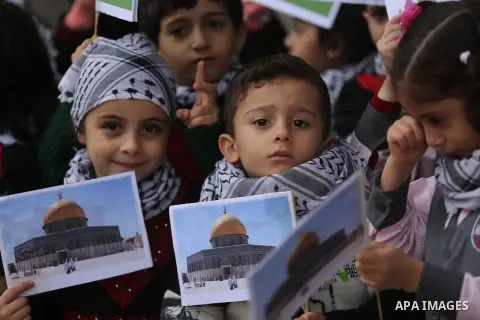 Palestinian children hold Palestine flags and pictures of Jerusalem during a protest in Gaza city, on December 6, 2017. U.S. officials say President Donald Trump will recognize Jerusalem as Israel's capital Wednesday, De...