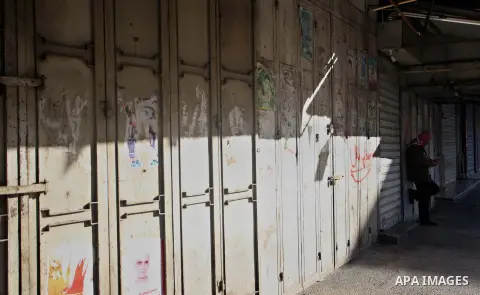 Palestinians walk past closed shops during a general strike over U.S. President Donald Trump's decision to recognize Jerusalem as the capital of Israel, in the West bank city of Nablus on December 7, 2017. Photo by Ayman...