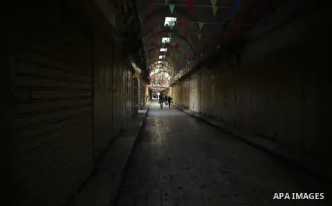 Palestinians walk past closed shops during a general strike over U.S. President Donald Trump's decision to recognize Jerusalem as the capital of Israel, in the West bank city of Nablus on December 7, 2017. Photo by Ayman...