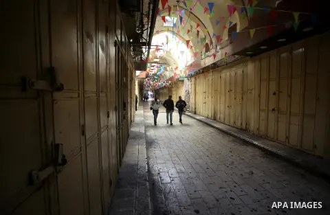 Palestinians walk past closed shops during a general strike over U.S. President Donald Trump's decision to recognize Jerusalem as the capital of Israel, in the West bank city of Nablus on December 7, 2017. Photo by Ayman...