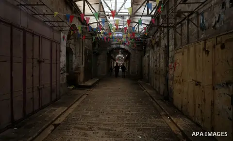 Palestinians walk past closed shops during a general strike over U.S. President Donald Trump's decision to recognize Jerusalem as the capital of Israel, in the West bank city of Nablus on December 7, 2017. Photo by Shadi...