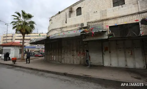 Palestinians walk past closed shops during a general strike over U.S. President Donald Trump's decision to recognize Jerusalem as the capital of Israel, in the West bank city of Nablus on December 7, 2017. Photo by Shadi...